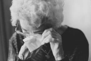Abused elderly woman crying