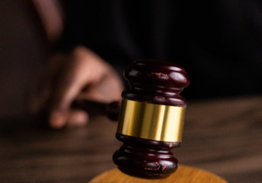 brown and gold gavel on brown wooden table