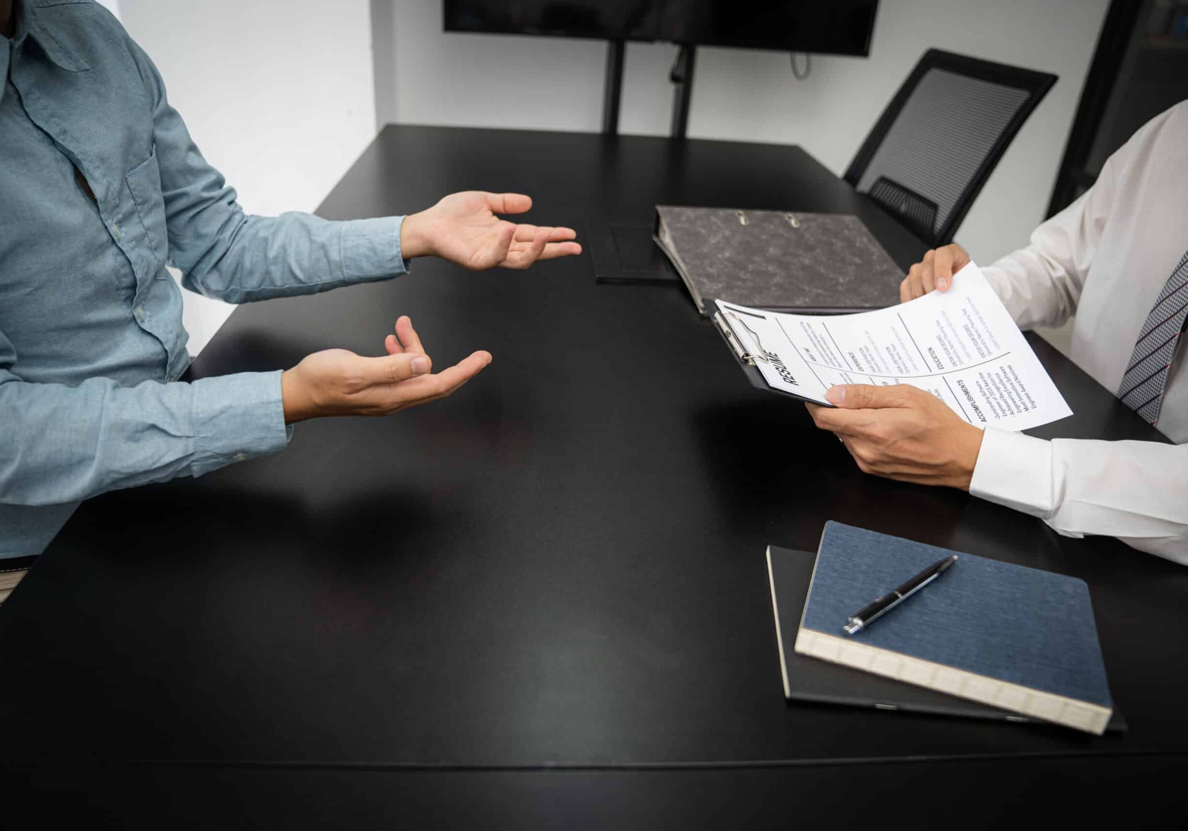 Examiner reading a resume during job interview at office Business and human resources concept